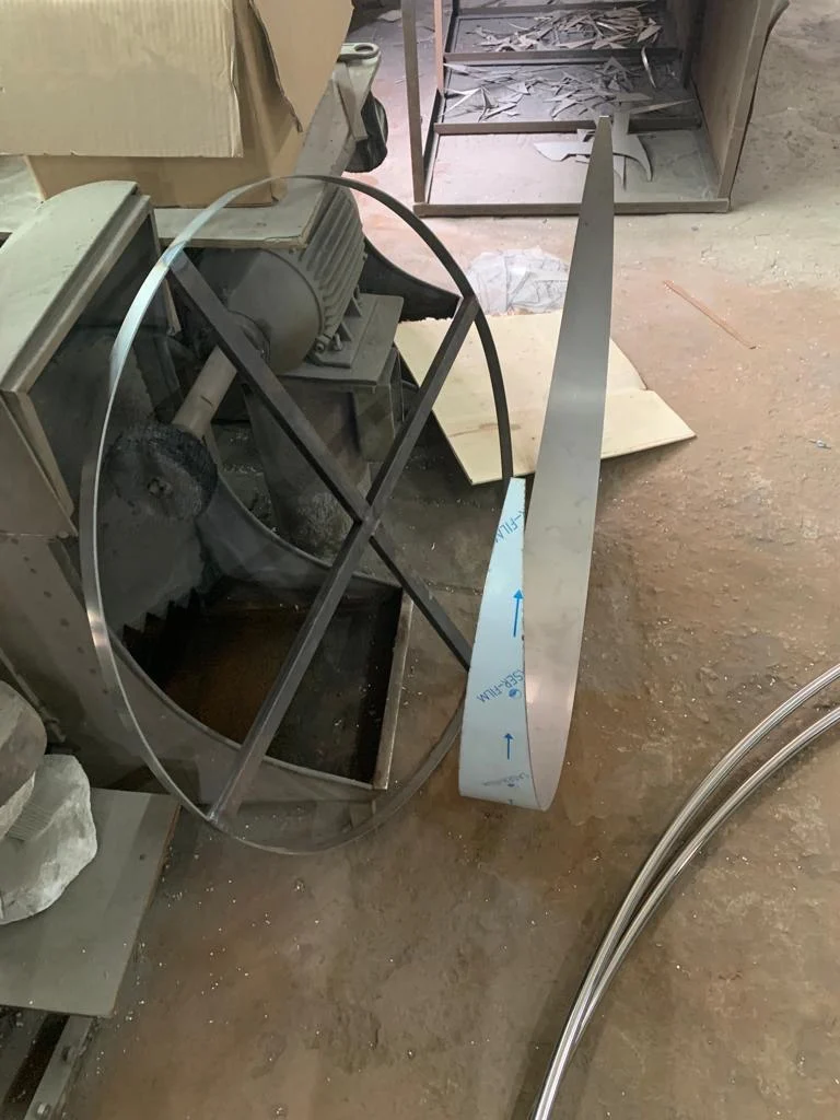 A circular metal component being worked on in the manufacturing workshop.