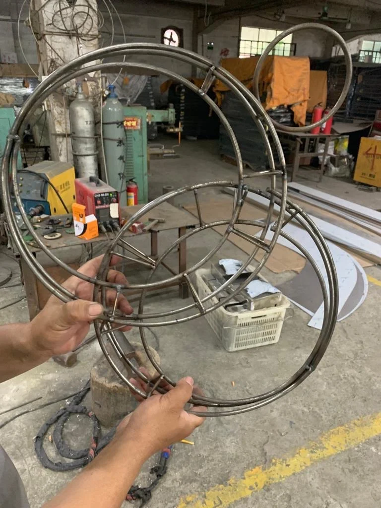 Luna’s polished metal rings in the fabrication workshop.